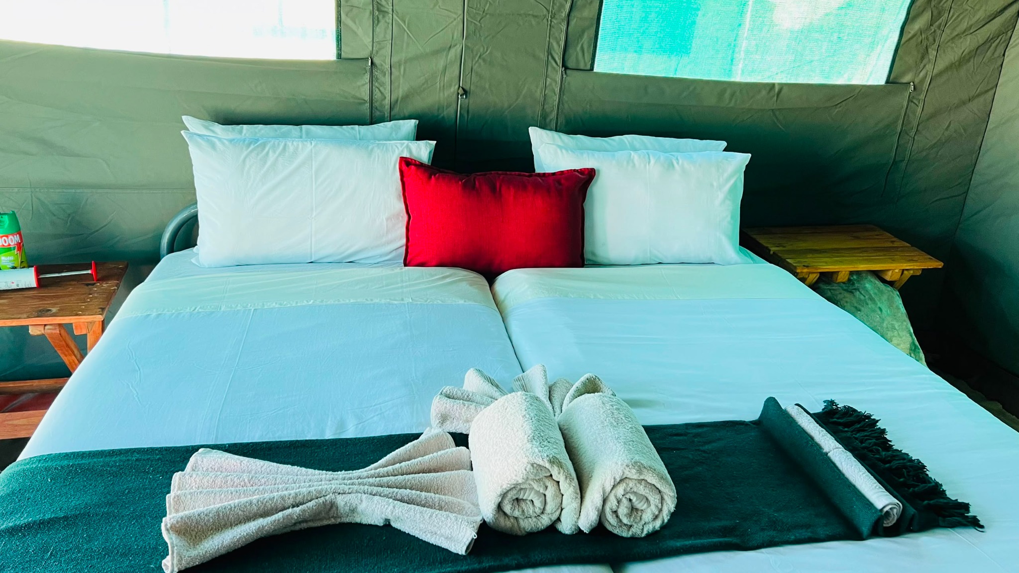 Comfortable bed and linen inside a Safari Addicts mobile tent